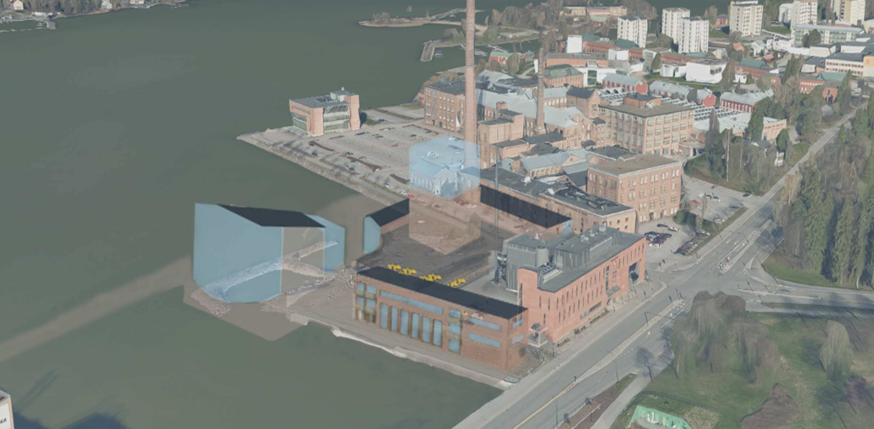 Flygbild av ett industriområde vid en vattendrag, med flera tegelbyggnader och en hög skorsten. Det finns också 3D-modeller av byggnaderna synliga i bilden.