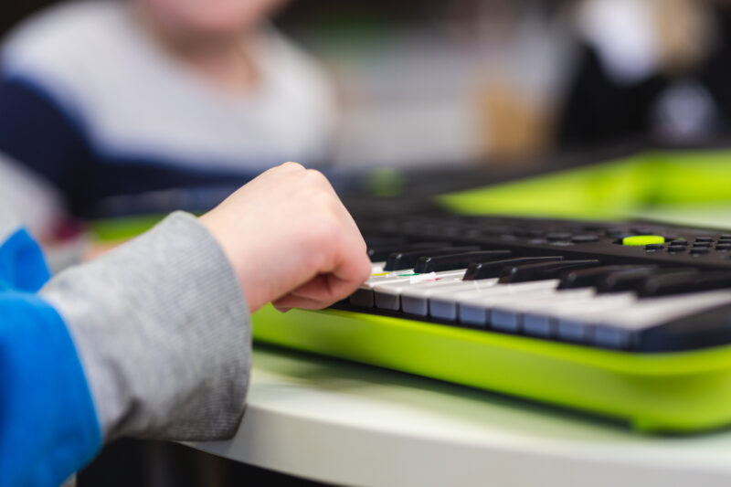 A child playing an electric piano.