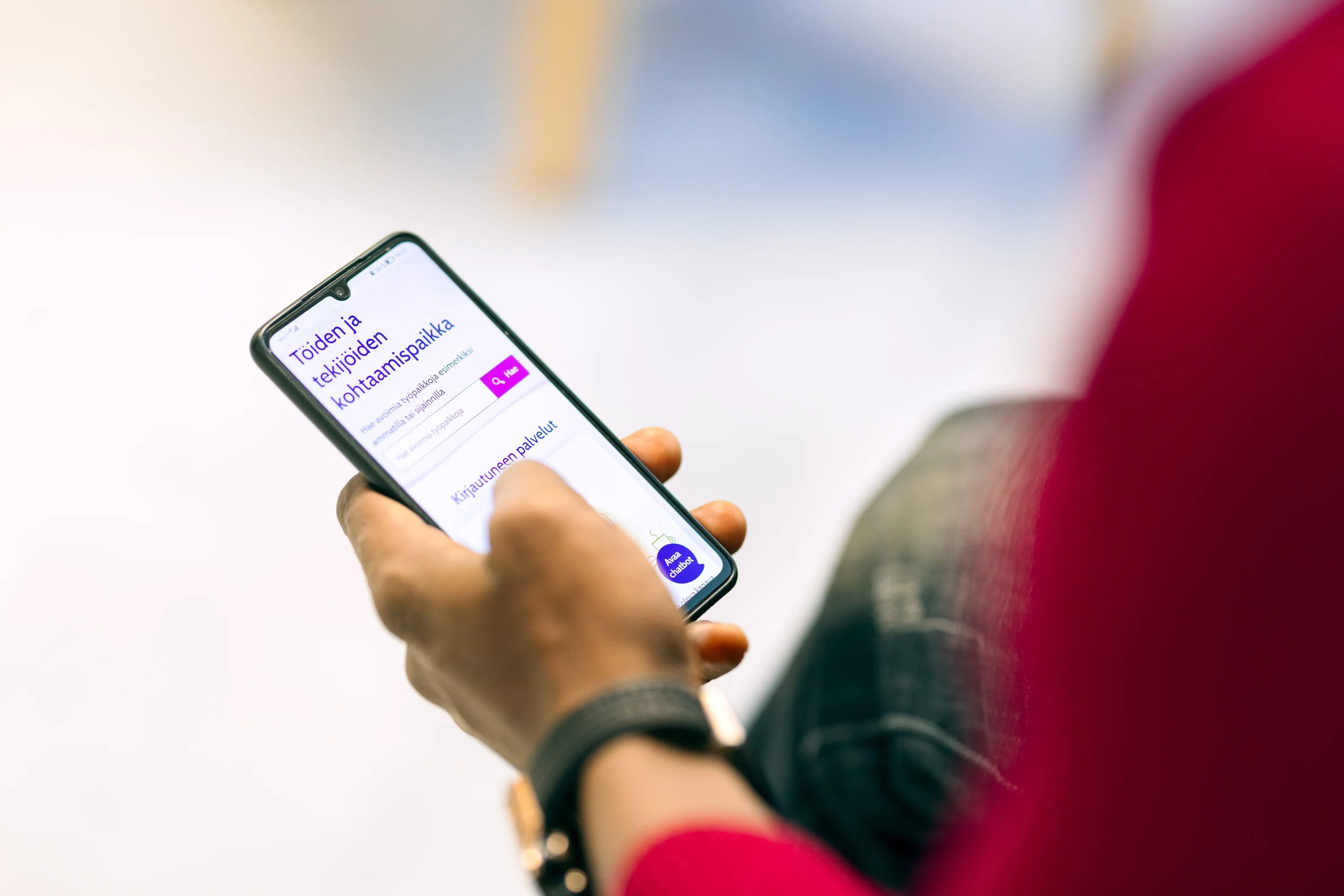 A person using a smartphone displaying a website about job and worker connections.
